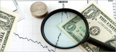 Illustration of a magnifying glass sitting on top of a dollar bill and a finance chart